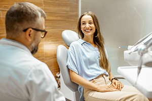 Female patient smiling at dentist at dental appointment