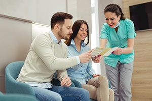 Dentist explains something to couple