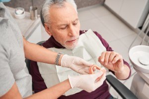 Man with dentures at the dentist