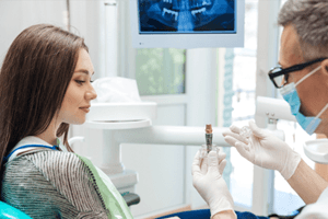 person with a dental implant smiling