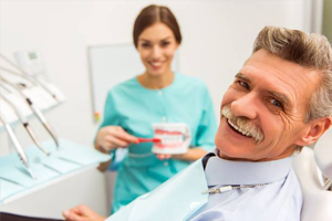 Smiling senior man in dental chair