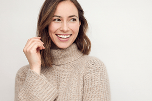 a woman smiling after getting Invisalign in Oakton