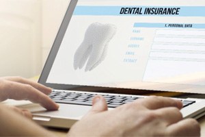 Patient filling out dental insurance information on computer