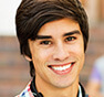 Young kid with dark hair and a bright smile