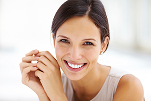 Woman with dark hair and a white smile