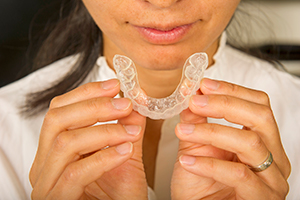 Woman holding a invisalign tray