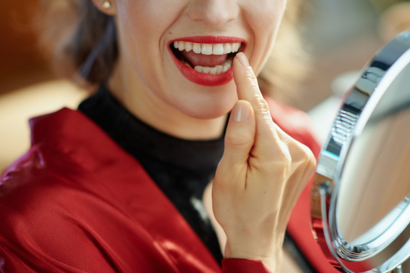 Woman pointing to her teeth