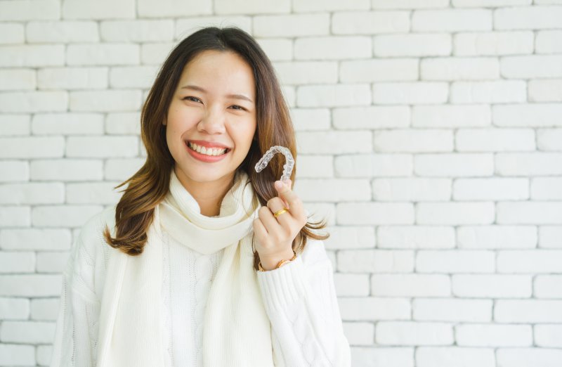 woman smiling with her Invisalign in Oakton