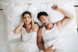 woman annoyed at her partner’s chronic snoring from sleep apnea