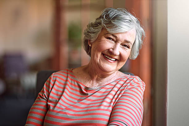 older person who got dental implants after menopause smiling 