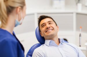 Man smiling while talking to his dentist